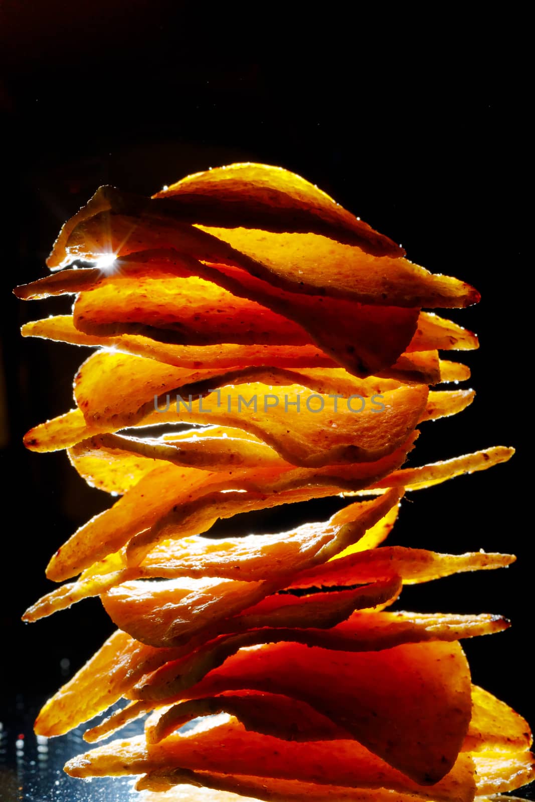 mexican nachos tortilla chips stack, black background by nikkytok