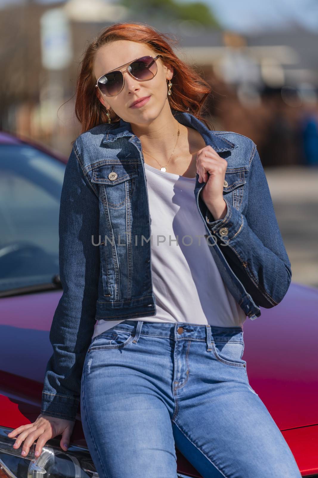 A gorgeous redhead model enjoys a spring day outdoors