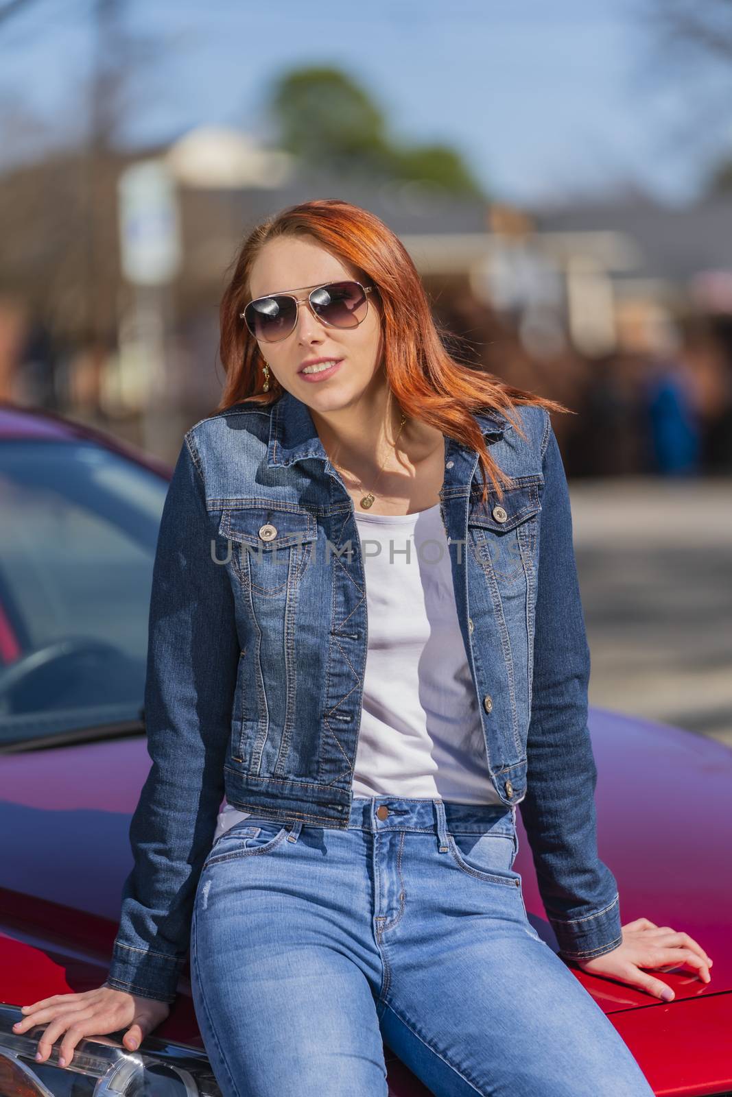 A gorgeous redhead model enjoys a spring day outdoors