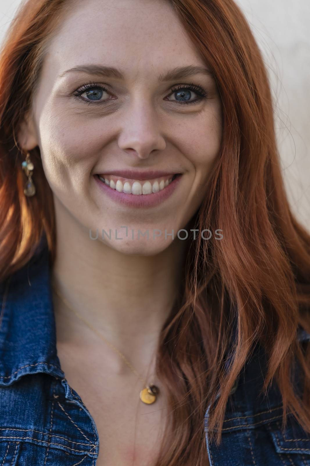 A gorgeous redhead model enjoys a spring day outdoors