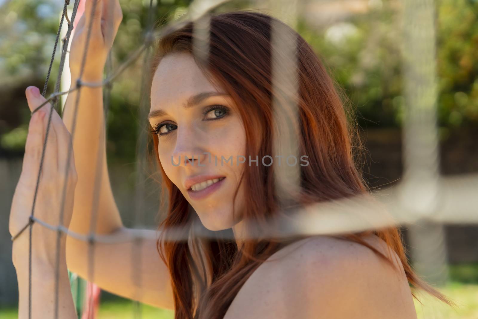 A redhead fitness model preparing to play volleyball