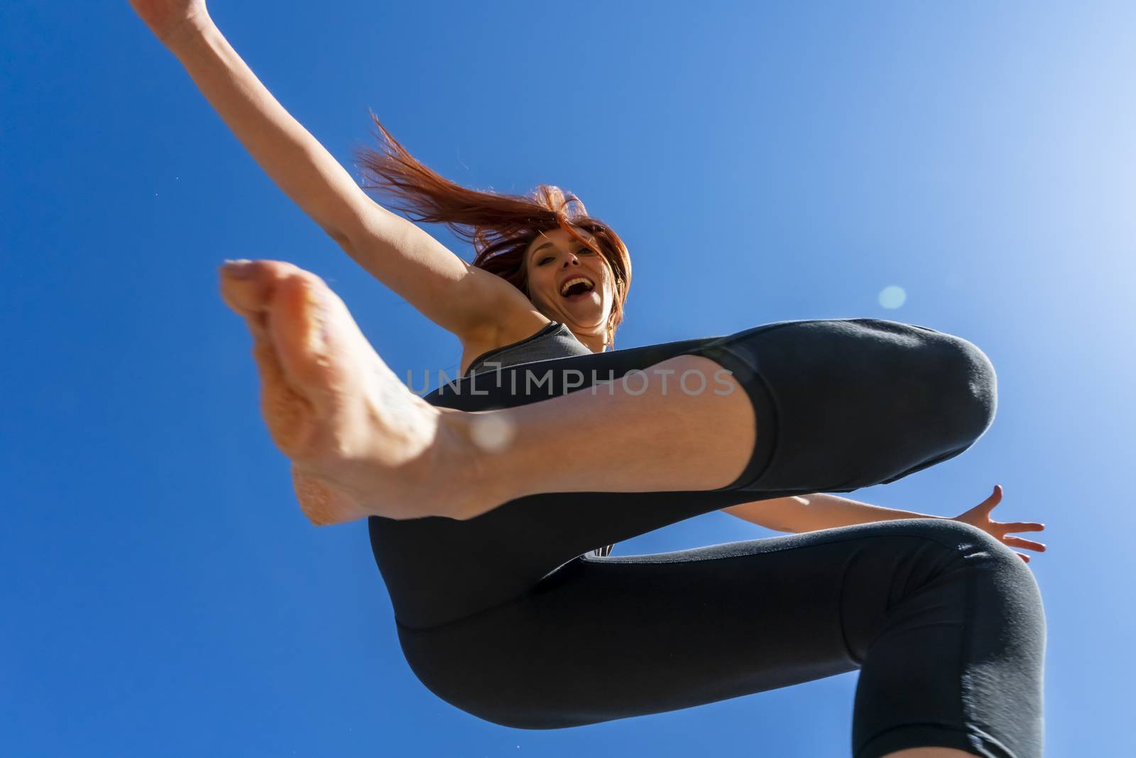 A redhead fitness model preparing to play volleyball