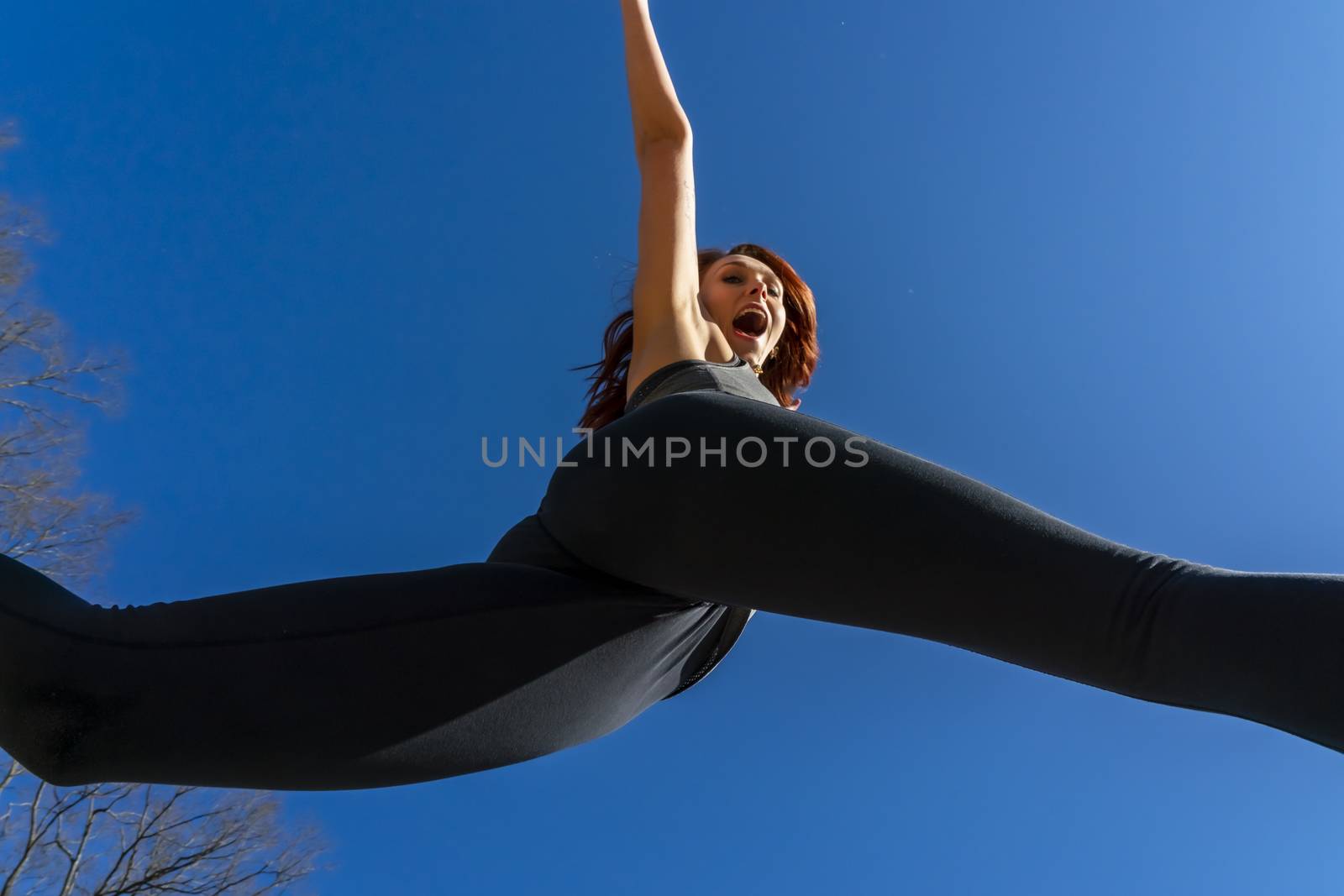 A redhead fitness model preparing to play volleyball