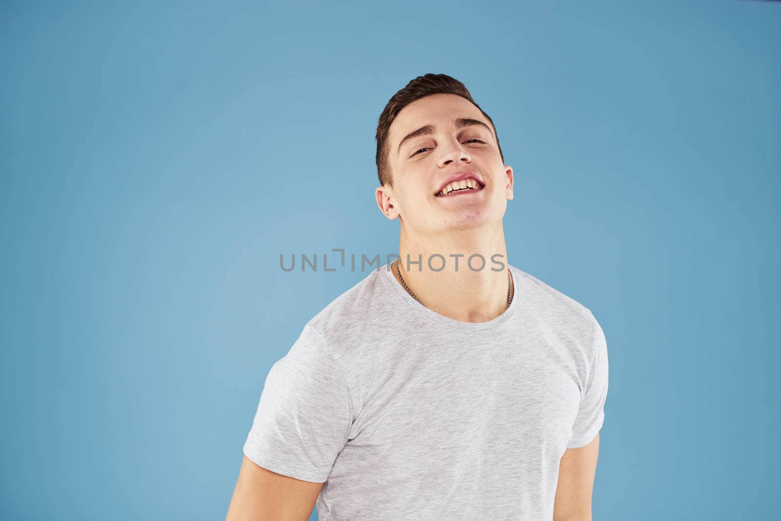 Emotional man in white t-shirt cropped view on blue background lifestyle by SHOTPRIME