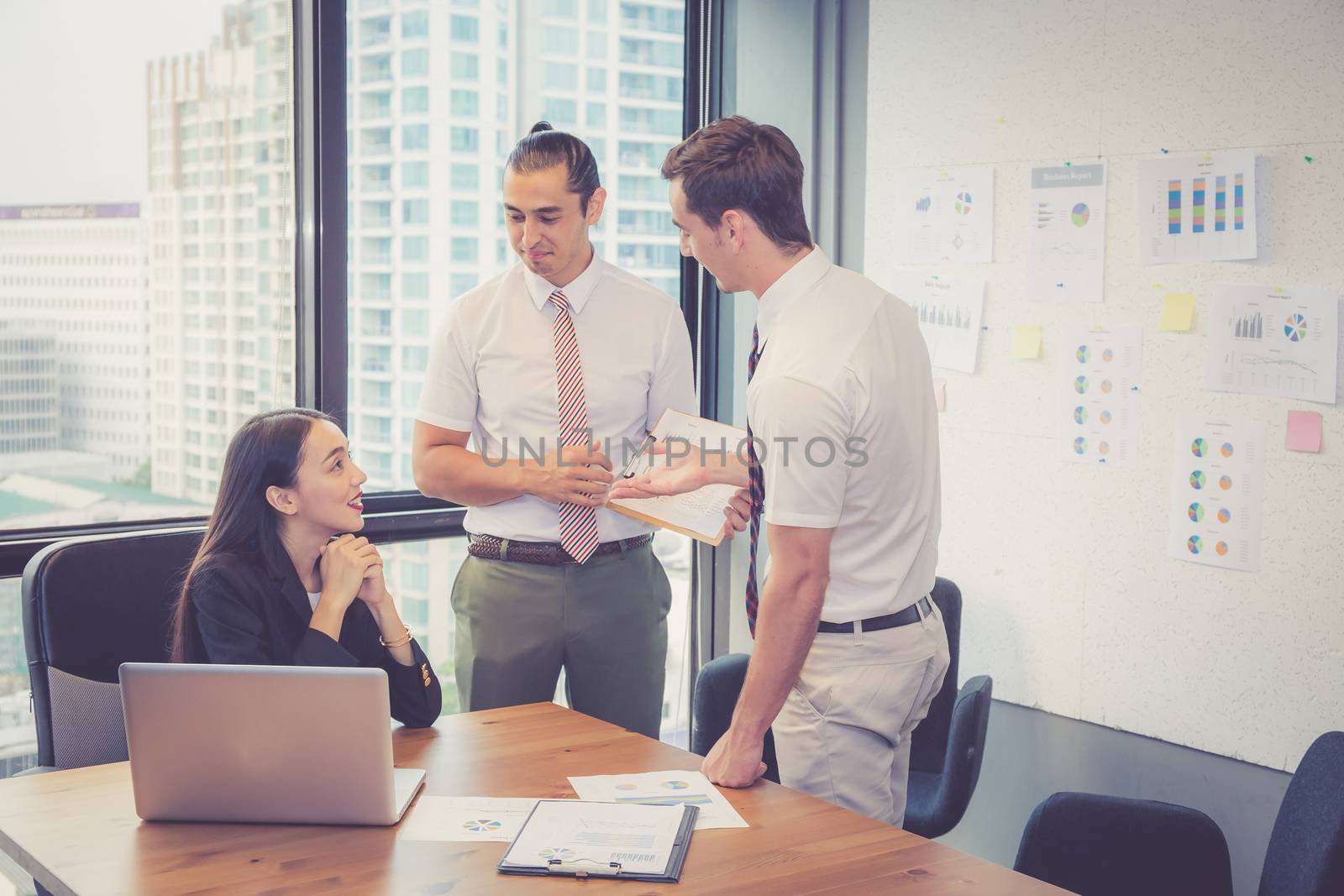 Business team having a meeting using laptop during a meeting and presents profit with chart and graph, leader talking employee with present report analysis and planning with brainstorm in teamwork.