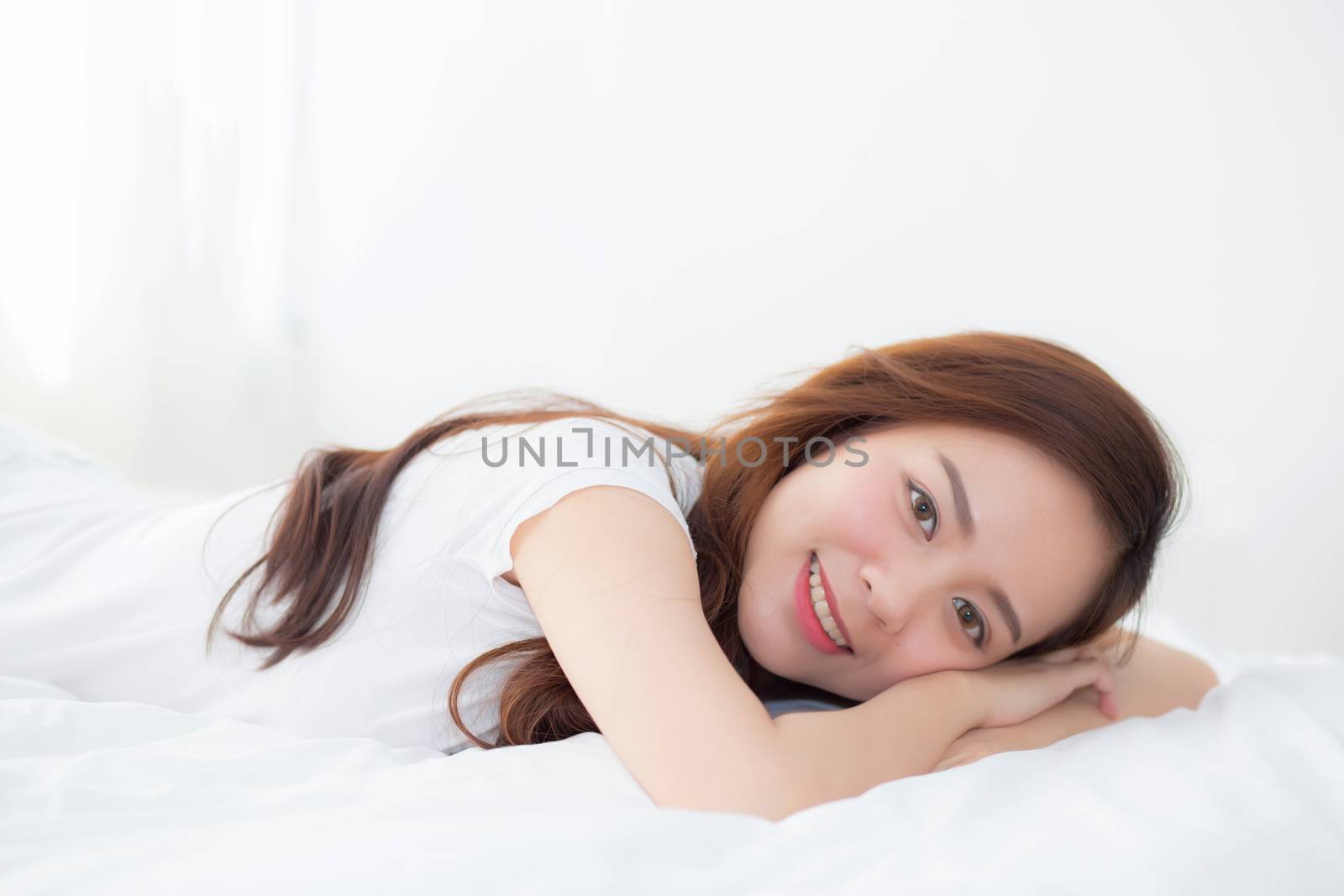 Portrait of beautiful asian young woman sleep lying in bed with head on pillow comfortable and happy with leisure, girl with relax  for health and lifestyle concept.