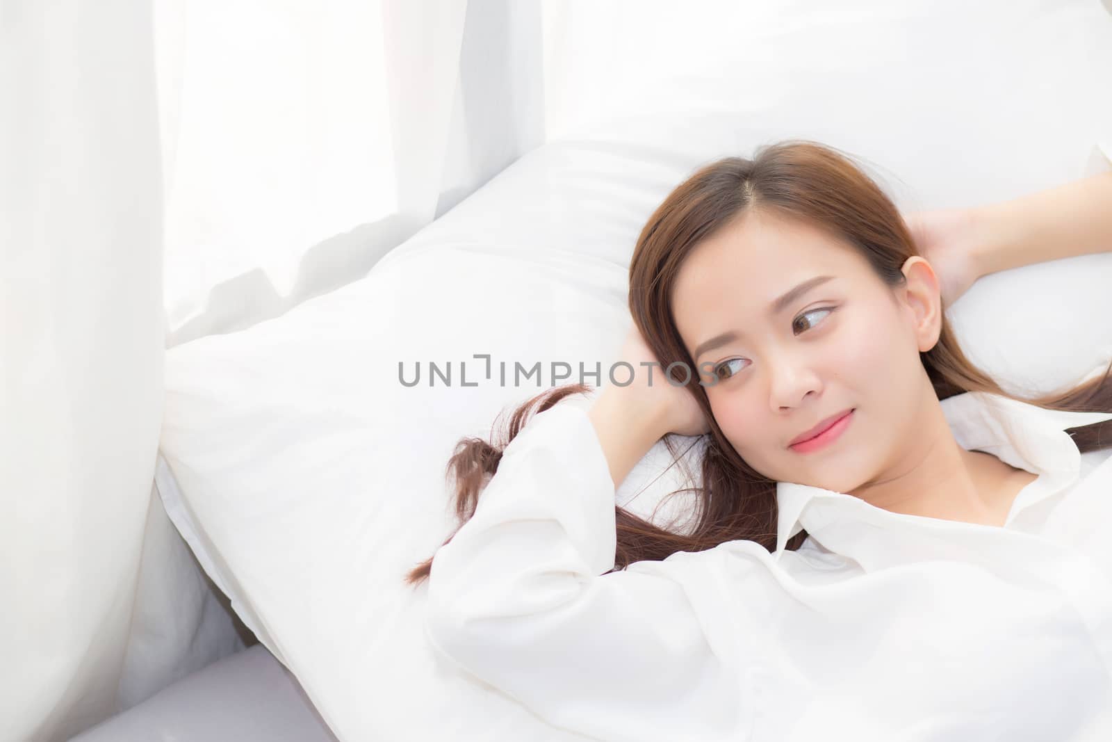 Beautiful asian young woman sleeping lying in bed with head on pillow comfortable and happy. girl with relax for health concept.