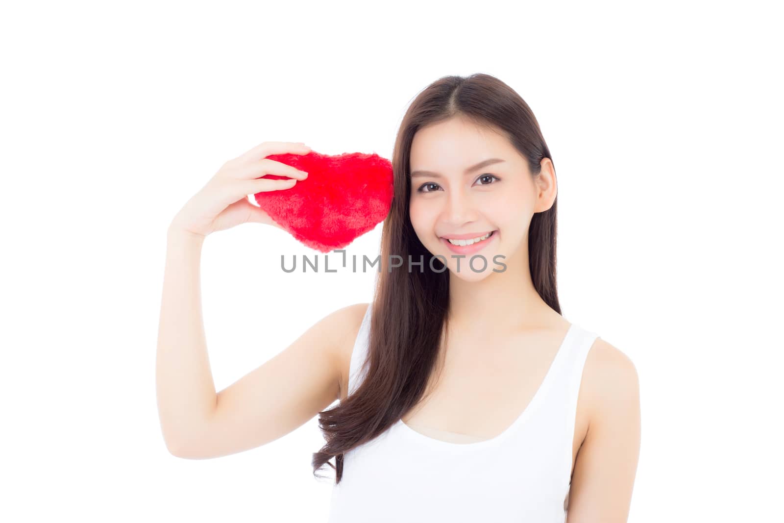 Portrait of beautiful asian young woman holding red heart shape pillow and smile isolated on white background, valentines day, holiday concept.