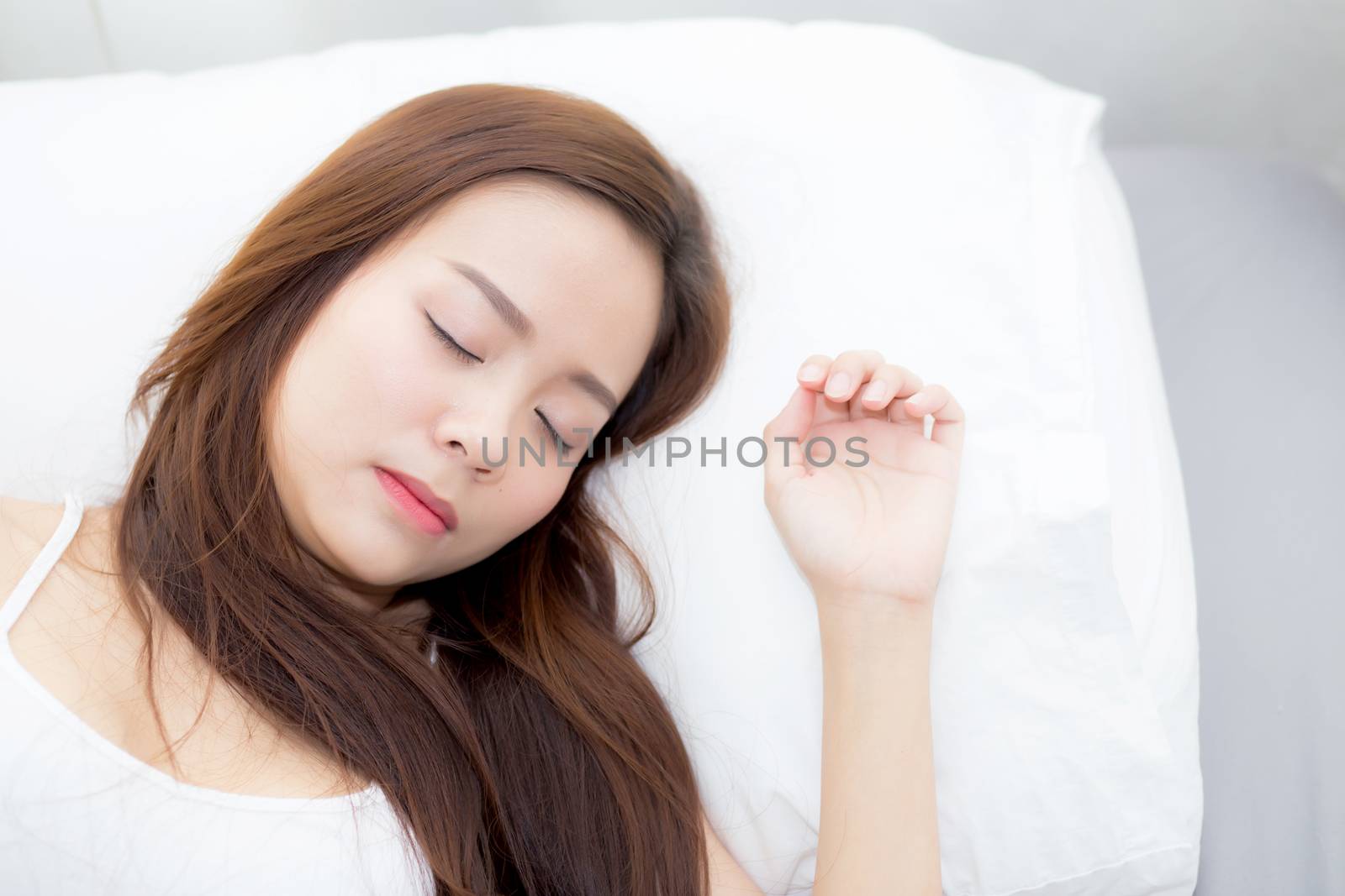 Portrait of beautiful asian young woman sleep lying in bed with head on pillow comfortable and happy with leisure, girl with relax  for health and lifestyle concept.