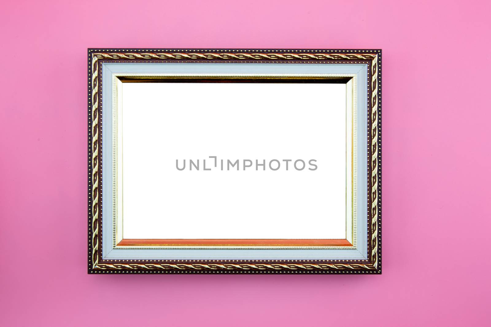 Gold frame photo border or picture with copy space isolated on pink background, portrait image gallery.