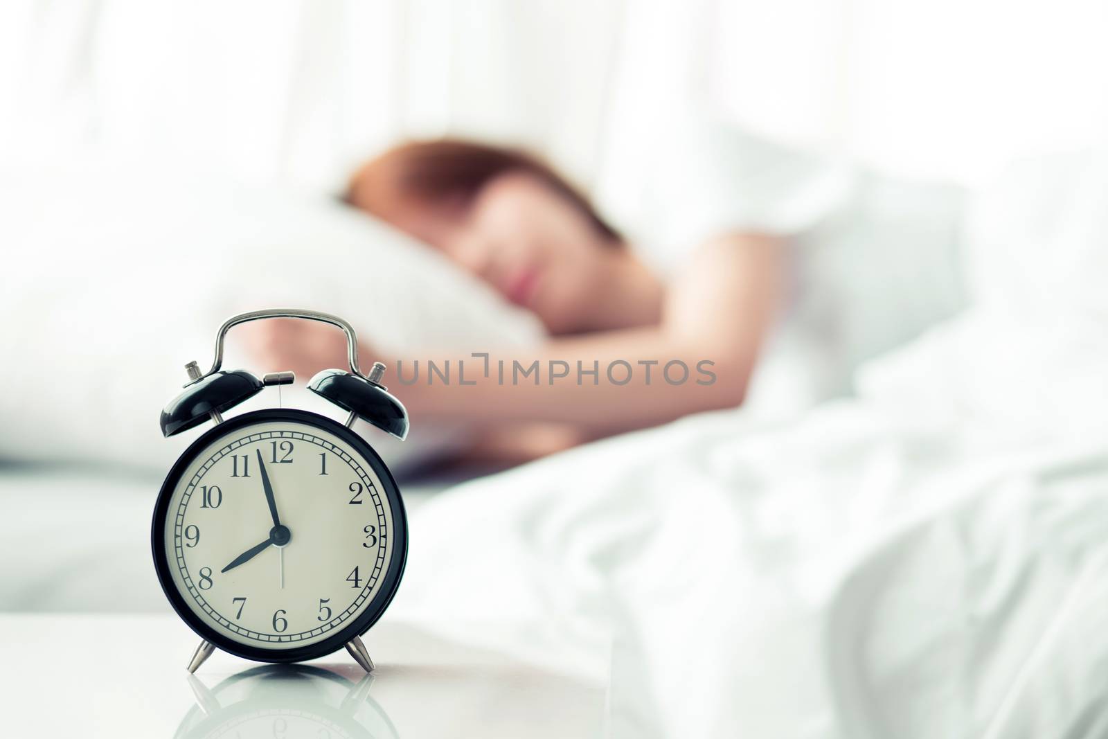 Beautiful asian young woman turn off alarm clock in good morning, wake up for sleep with closeup foreground alarm clock, relax and lifestyle concept.
