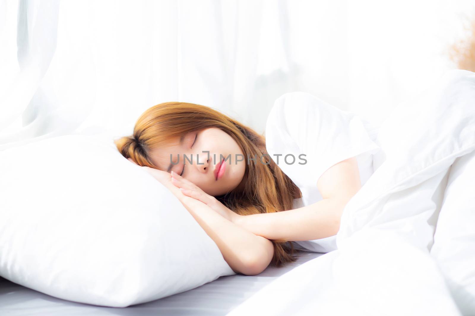 Portrait of beautiful asian young woman sleep lying in bed with head on pillow comfortable and happy with leisure, girl with relax  for health and lifestyle concept.