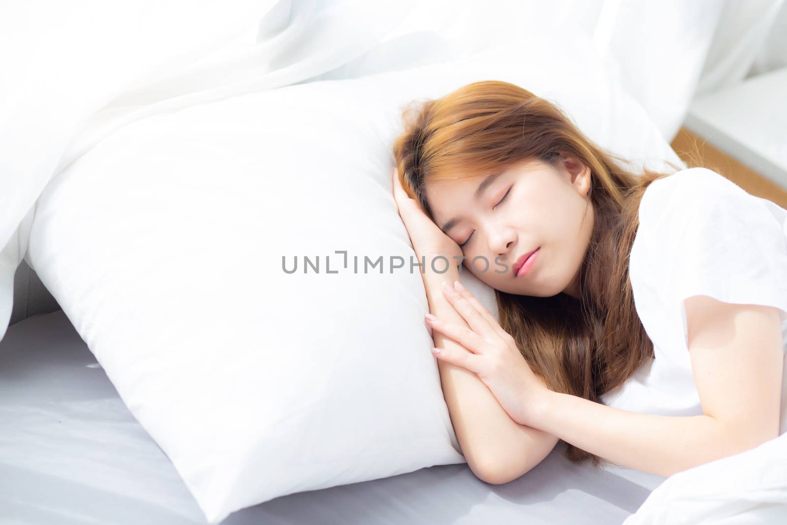 Portrait of beautiful asian young woman sleep lying in bed with head on pillow comfortable and happy with leisure, girl with relax  for health and lifestyle concept.