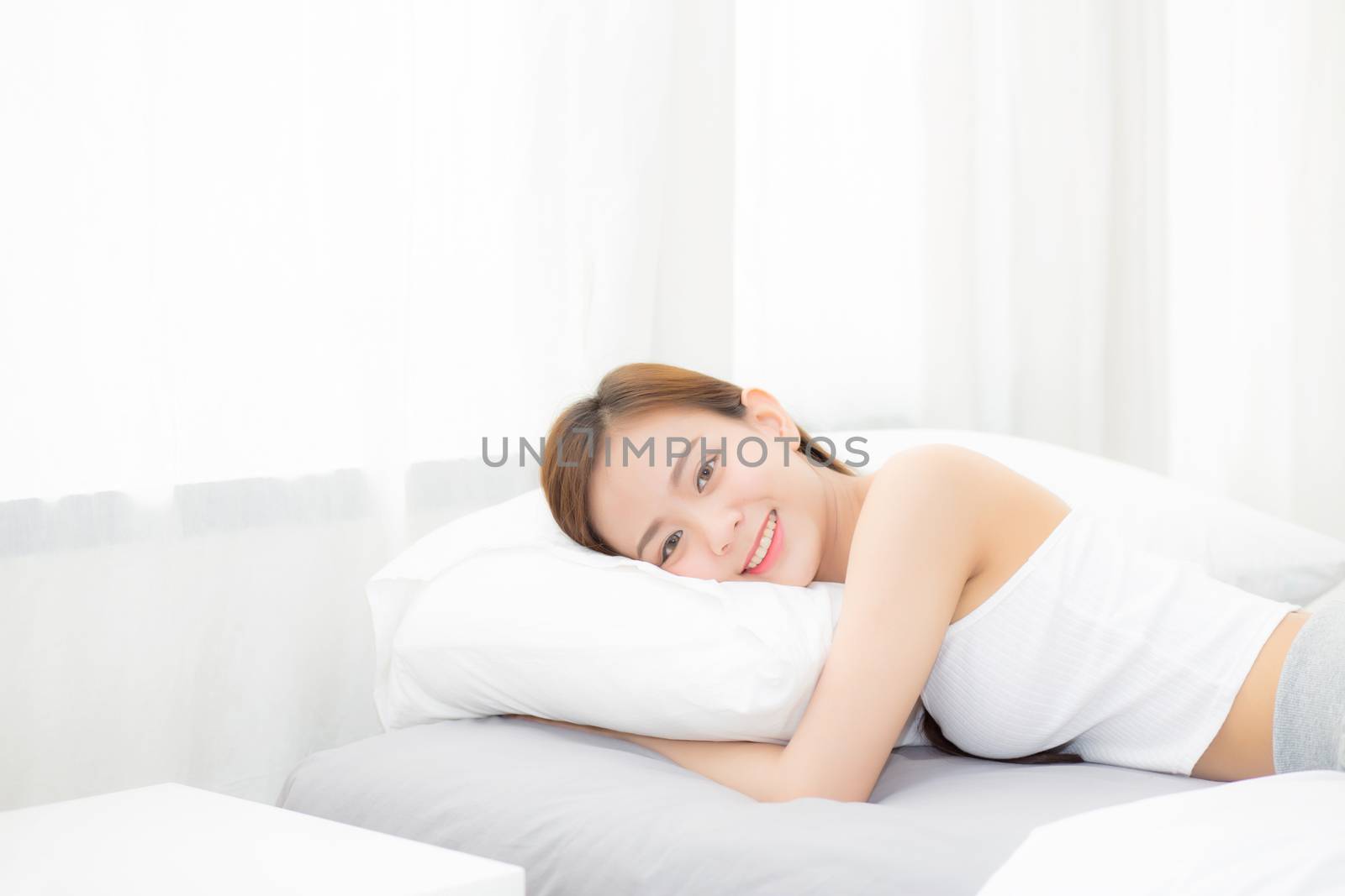 Portrait of beautiful asian young woman sleep lying in bed with head on pillow comfortable and happy with leisure, girl with relax  for health and lifestyle concept.