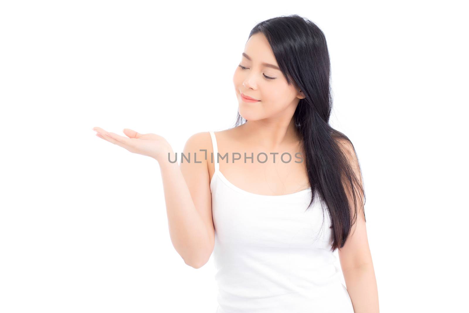 Asian beautiful young woman showing with healthy clean skin presenting something empty copy space on the hand isolated on white background, beauty concept.