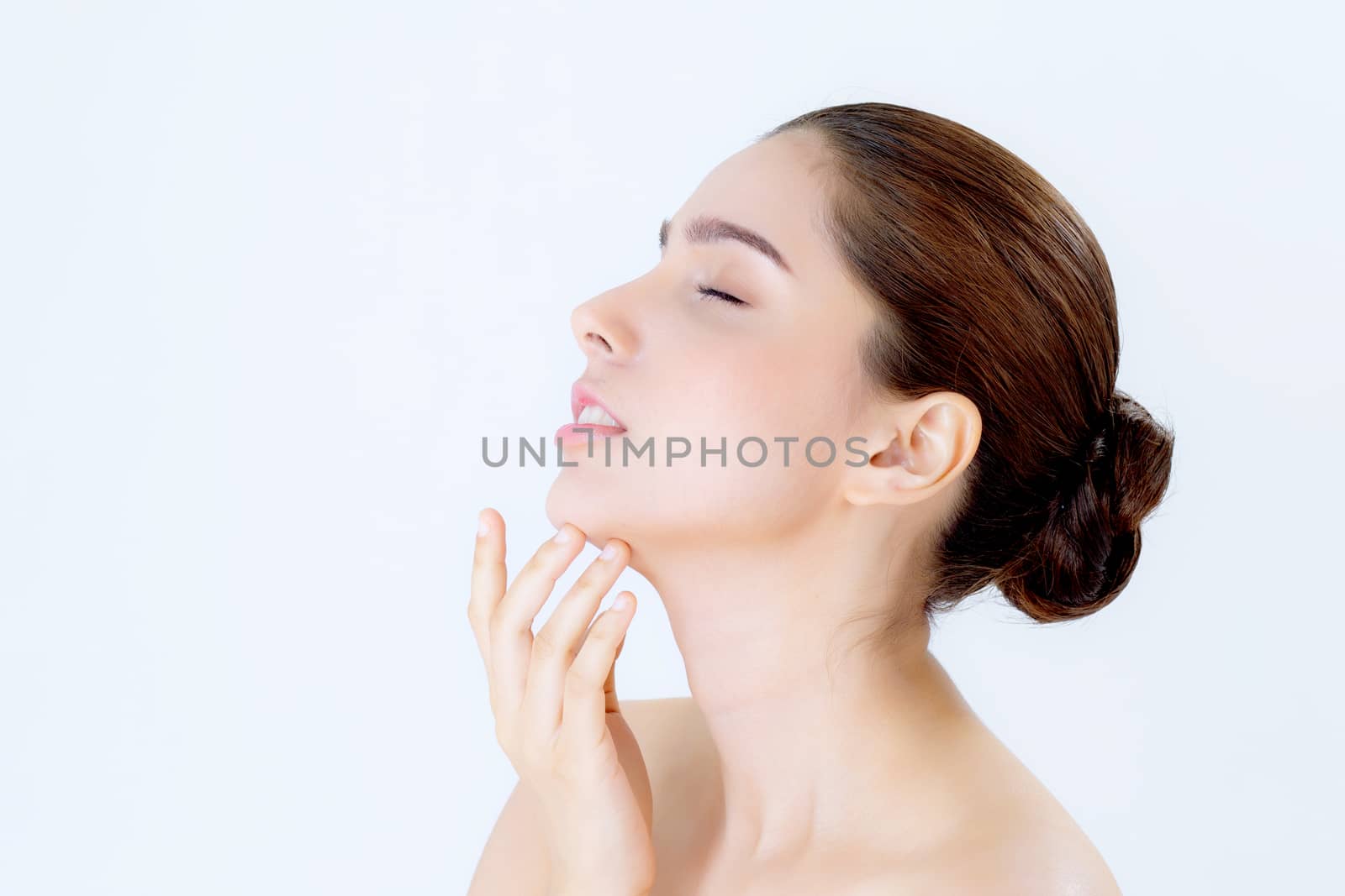 Portrait of beautiful asian brunette woman makeup of cosmetic, girl hand touch chin and smile attractive, face of beauty perfect with wellness isolated on white background with skin healthcare concept.