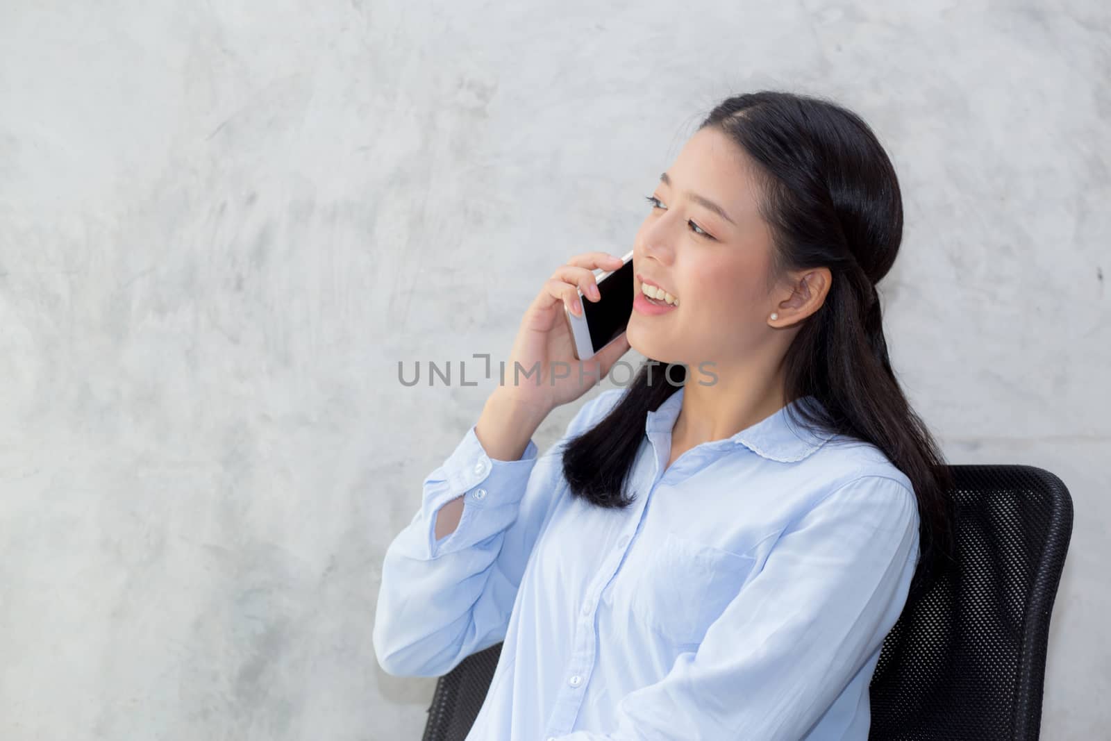 Beautiful young asian woman talking smart mobile phone and smile by nnudoo