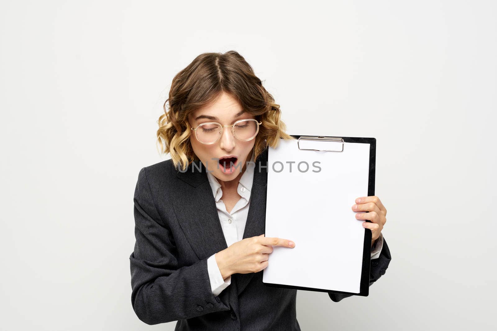 Business woman with a folder of documents on a light background cropped view and shirt suit. High quality photo