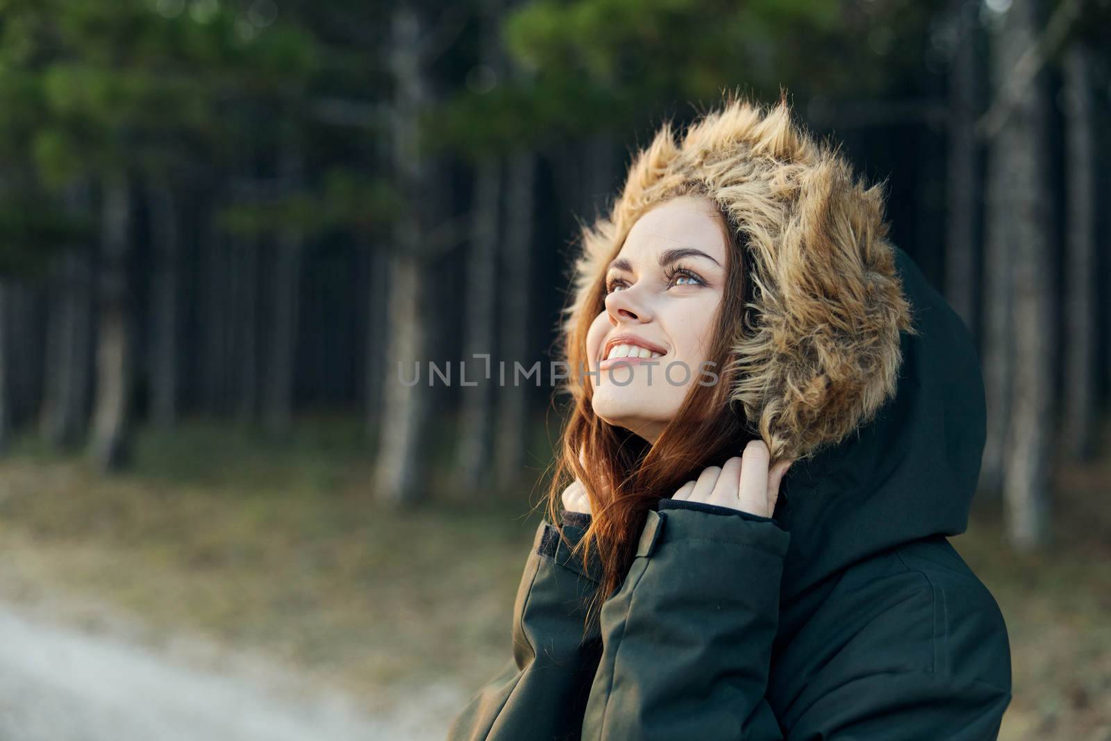 Smiling woman in hooded jacket looking upstairs travel lifestyle. High quality photo