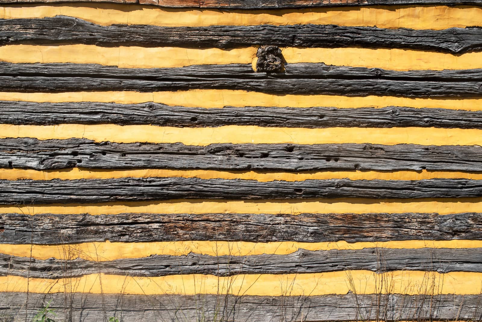 Close up of outside wall of colonial log cabin by marysalen