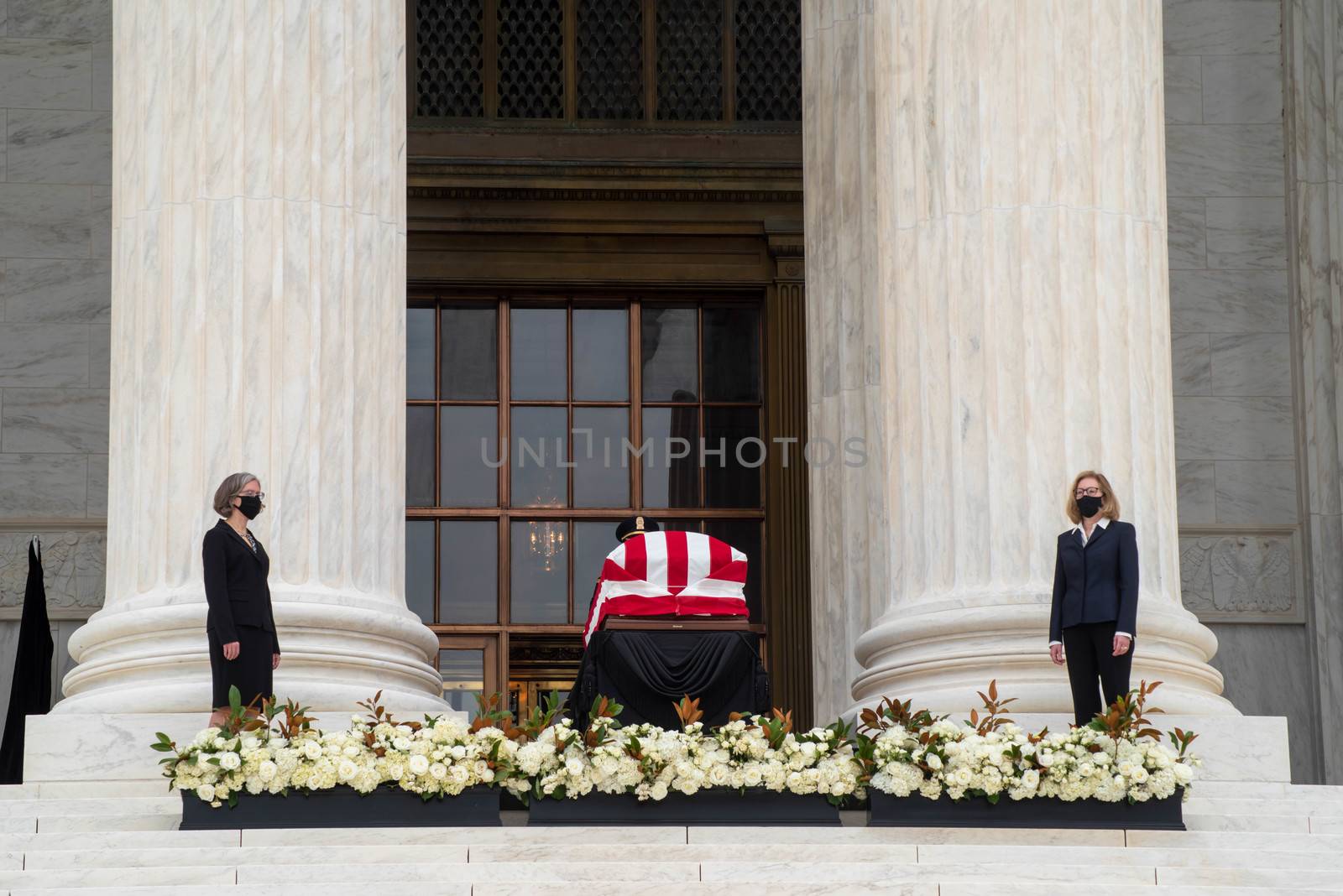 Washington, DC, USA / 9/24/2020: Justice Ruth Bader Ginsburg's casket draped in an American flag on the steps of the Supreme Court.