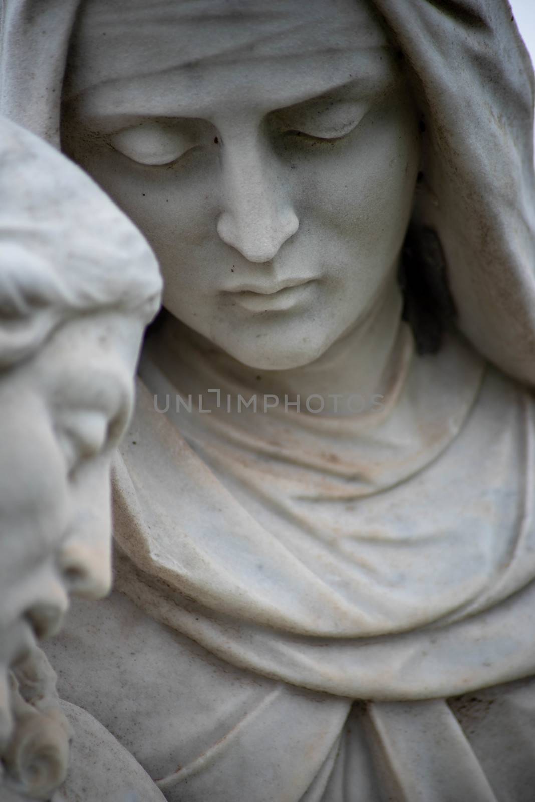 Close up of Mary in Victorian cemetery pieta statue. by marysalen