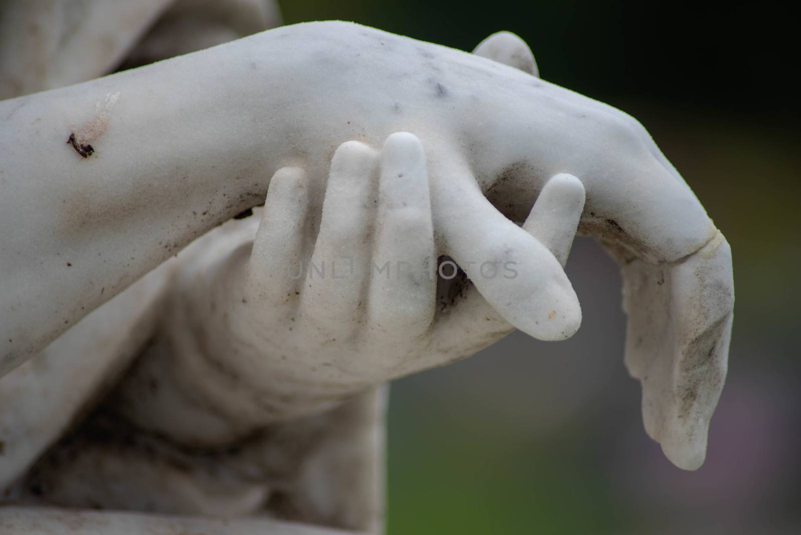 Stone sculpted hands of Jesus and Mary in an old cemetery by marysalen