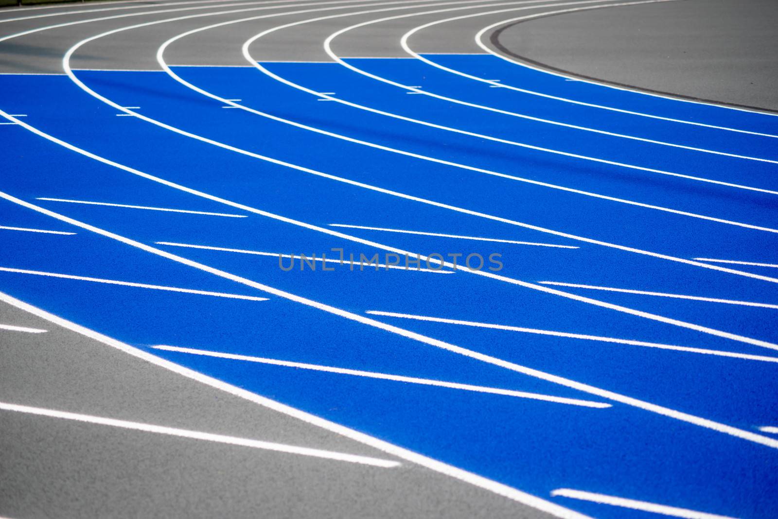 Curved blue running sports track, racing, athletics by marysalen