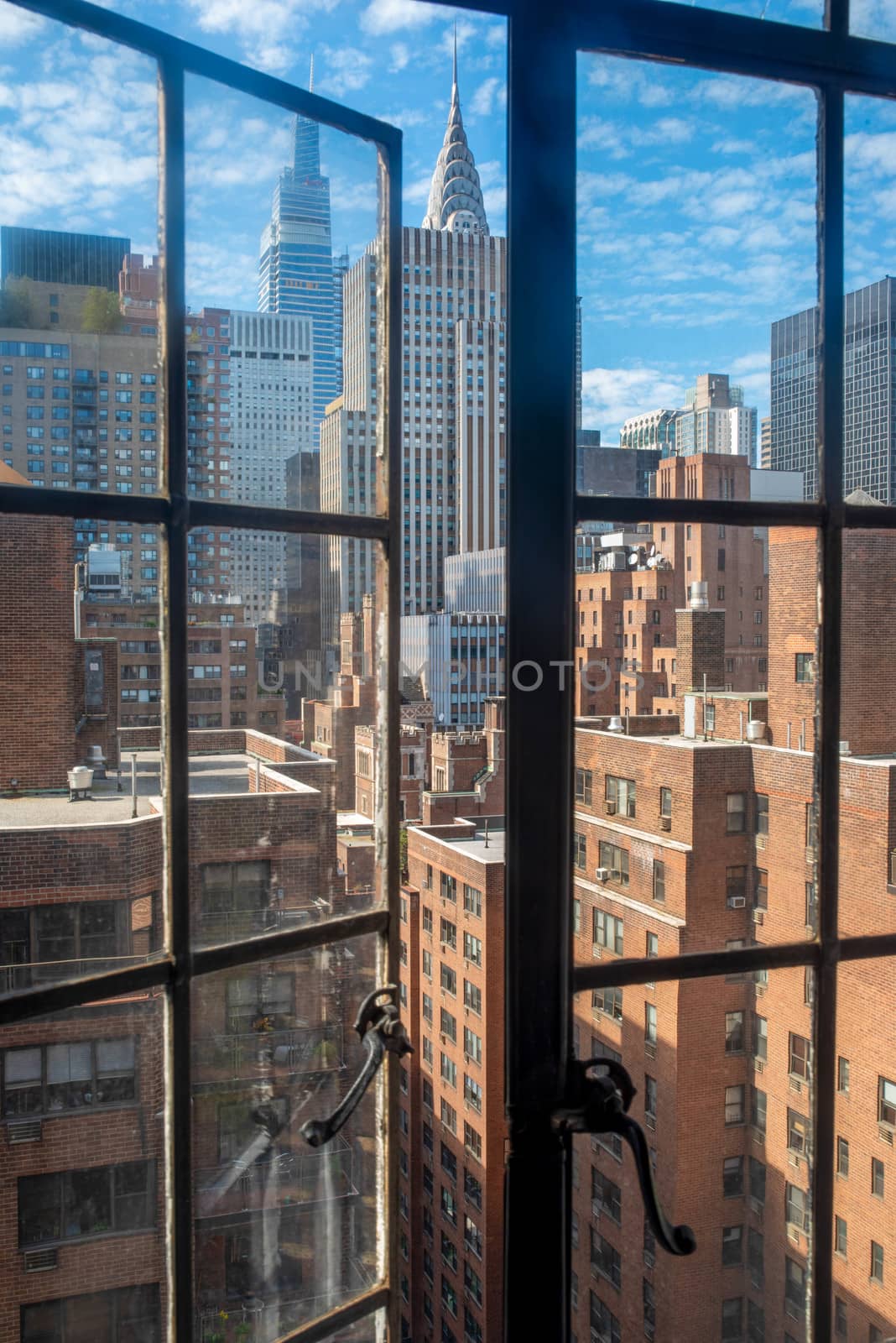 Manhattan skyline viewed through old fashioned open window. by marysalen