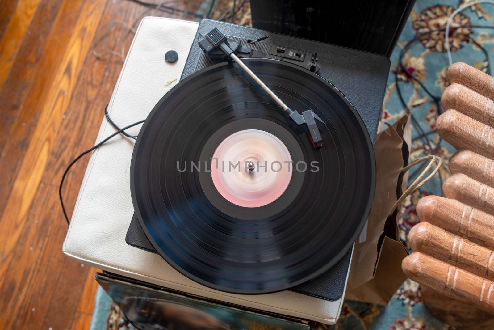 Seventies vinyl record spins on turntable by marysalen