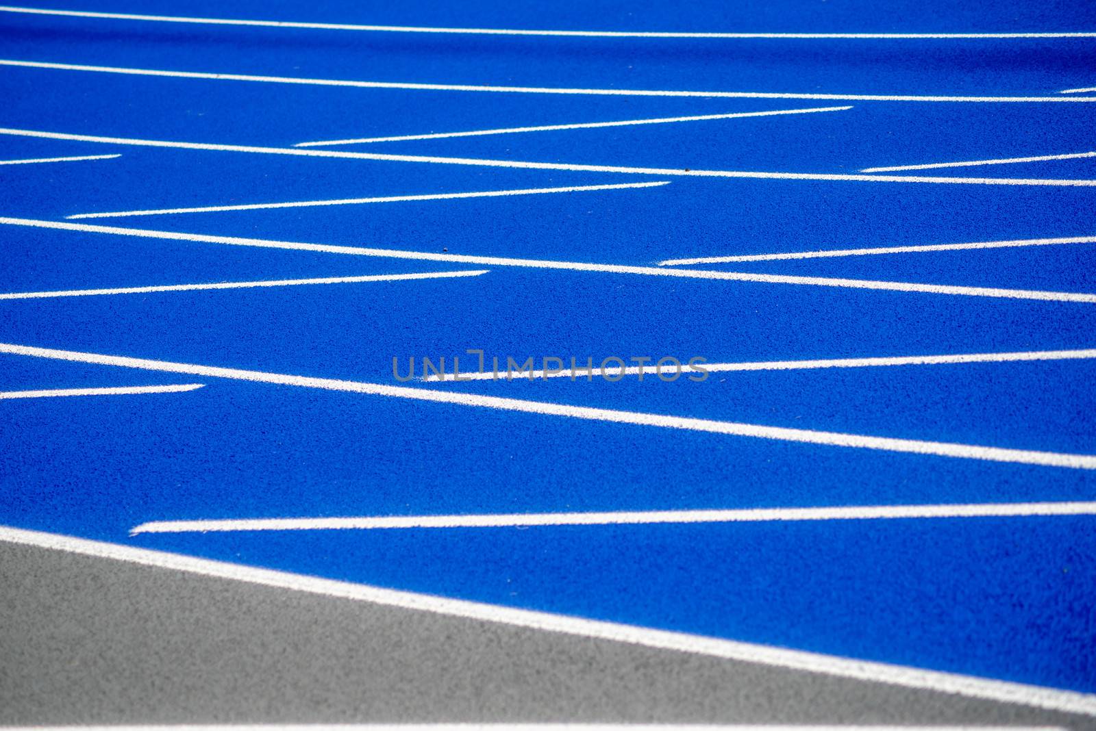 White lines on surface of blue running track. by marysalen