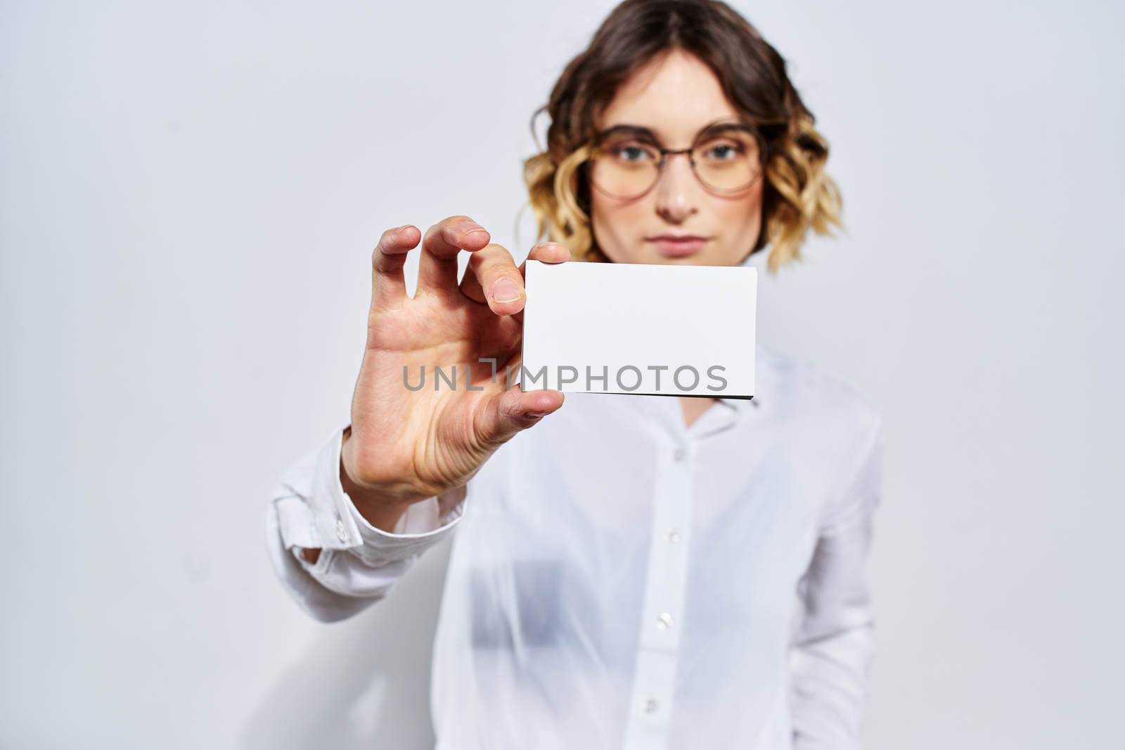 Business woman with card in hand light background credit card mockup. High quality photo