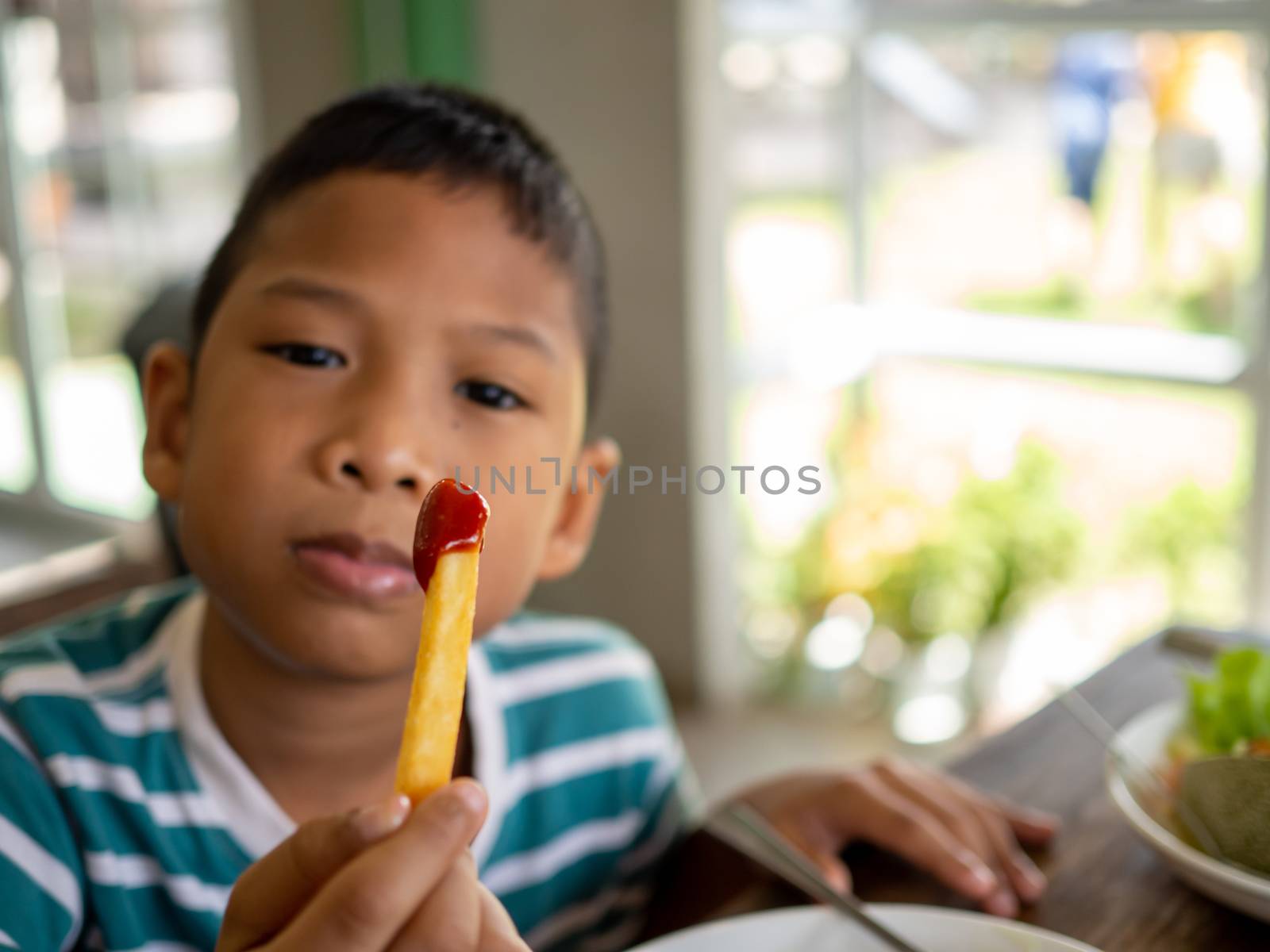 French fries with tomato sauce In the boy's hand