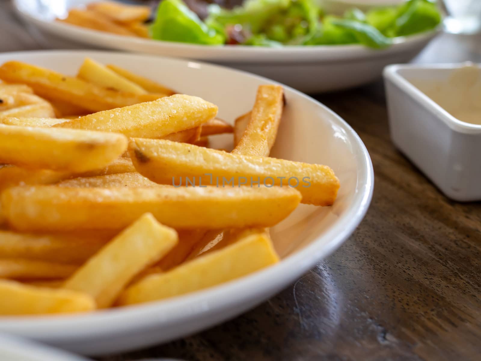 French fries are on a white plate. With copy space by Unimages2527