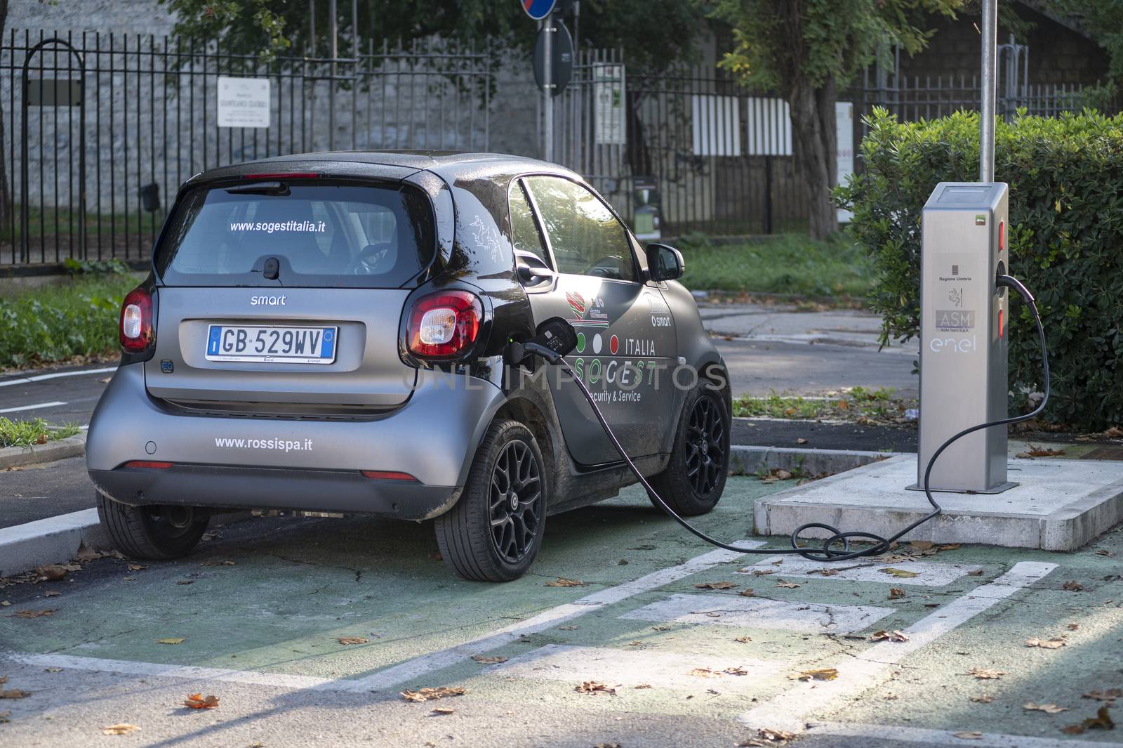 terni,italy october 28 2020:electric car being recharged attached to the column