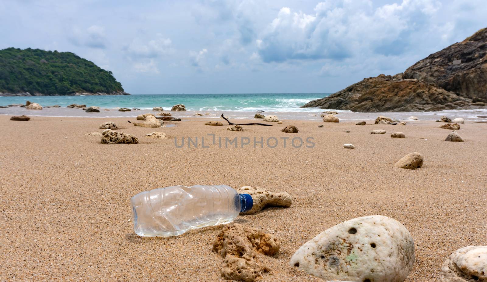 Plastic bottle waste is an environmental pollution on the beach by pkproject