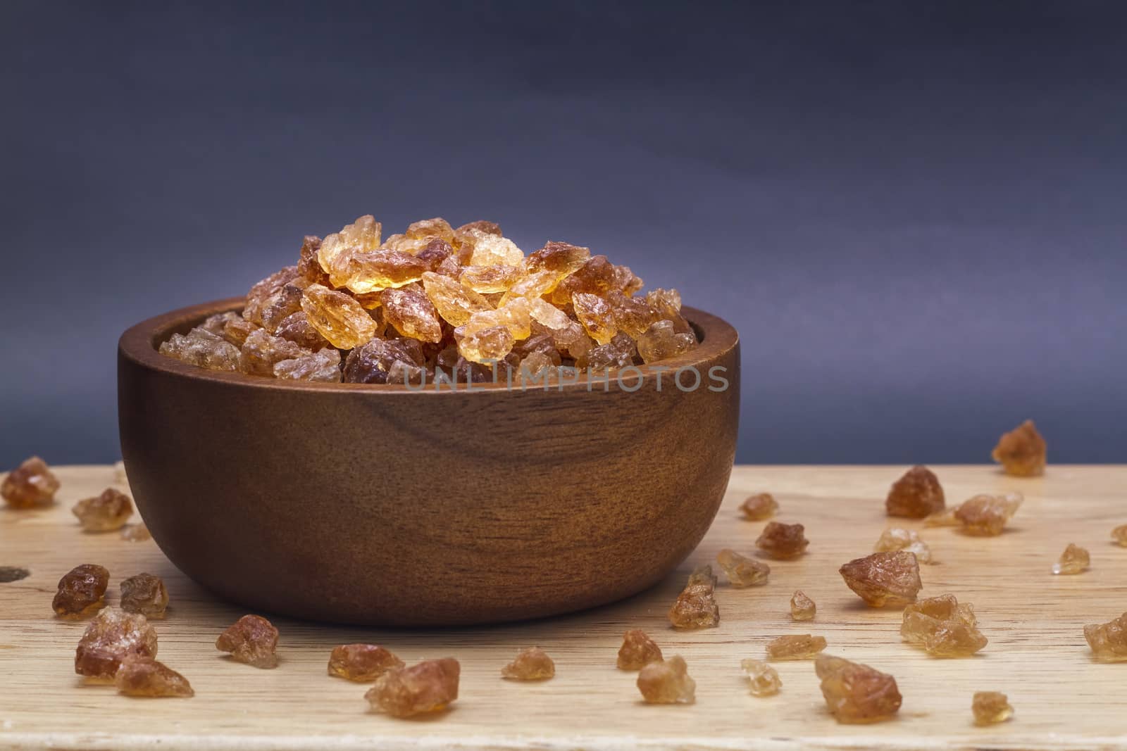 Brown rock sugar in the wooden bowl