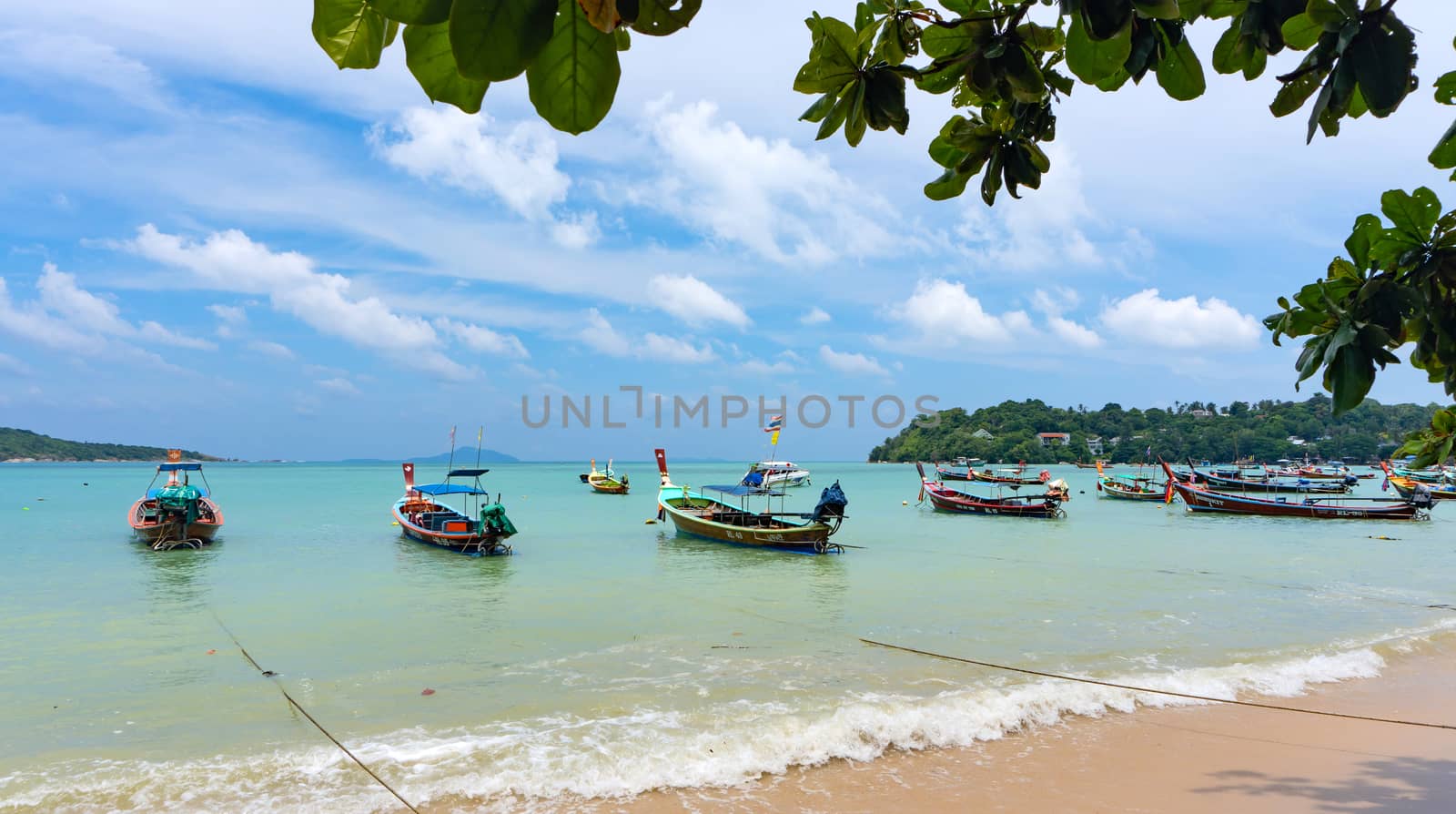 Phuket, Thailand - 06 August 2020: Fishing boats moored at Chalong Bay Pier.