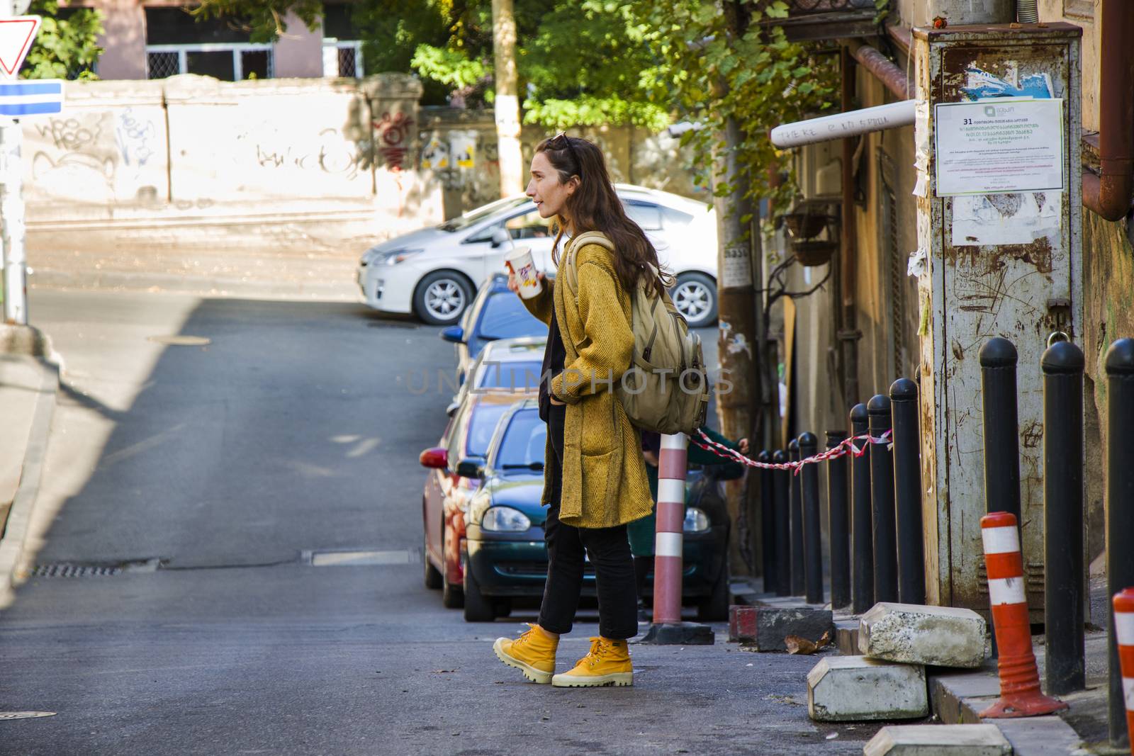 Woman in the casual cloth and yellow boots in the street, Tbilisi, Georgia