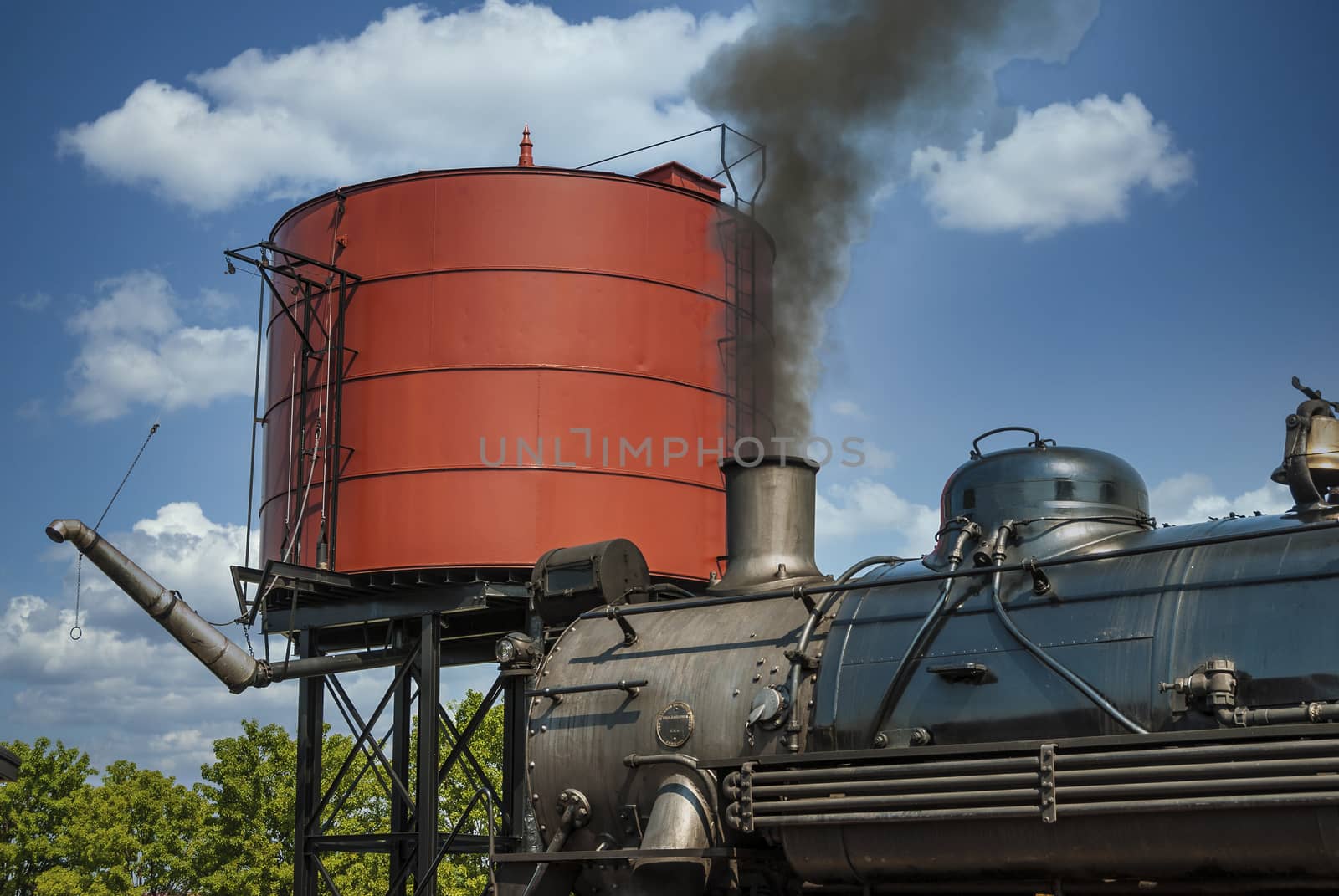 Steam Engine to get Water by Water Tower on a Sunny Day