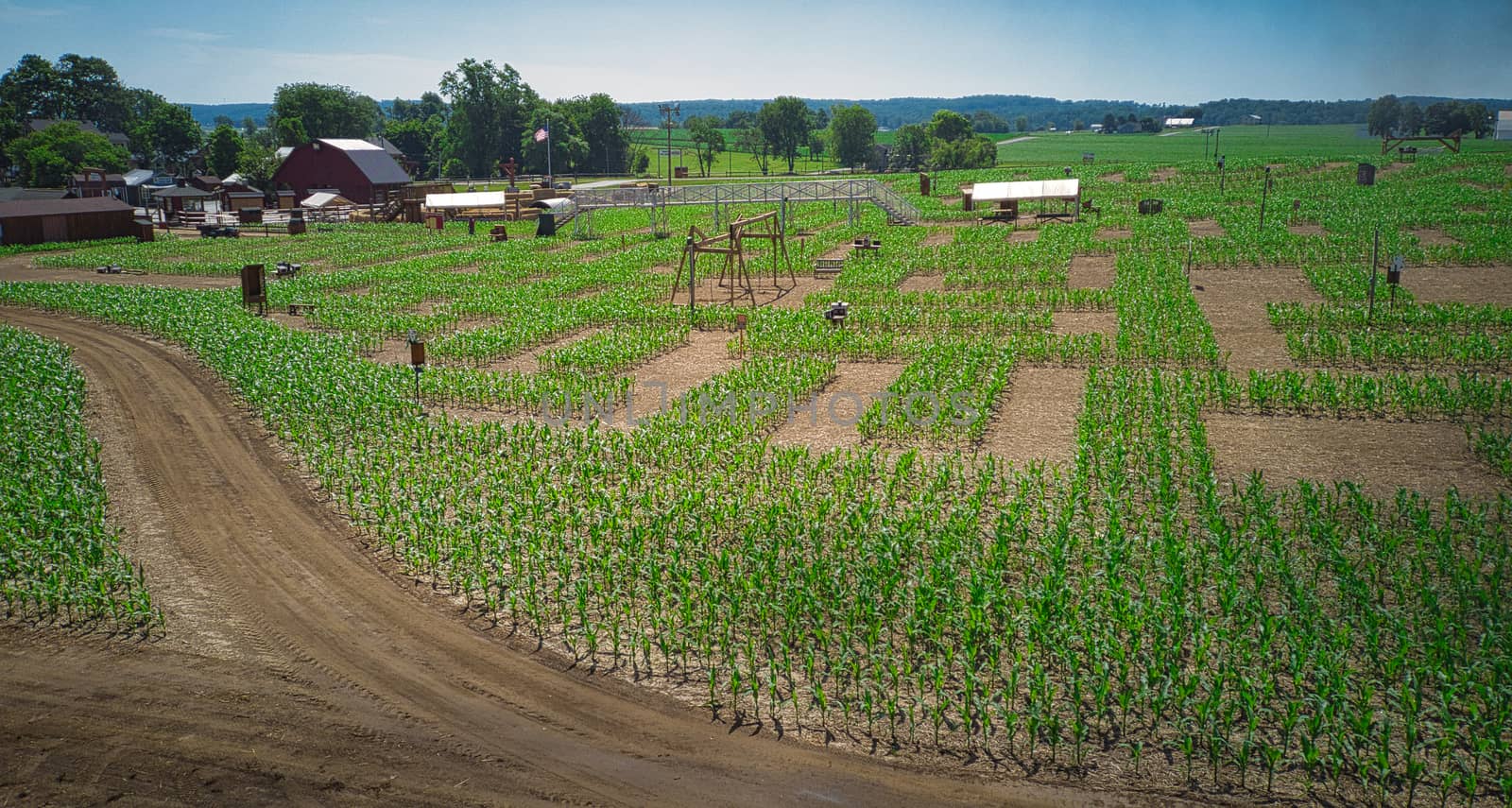 Steam Passenger Train Traveling Thru Countryside from Train Passenger View of a Newly Planted Corn Maze
