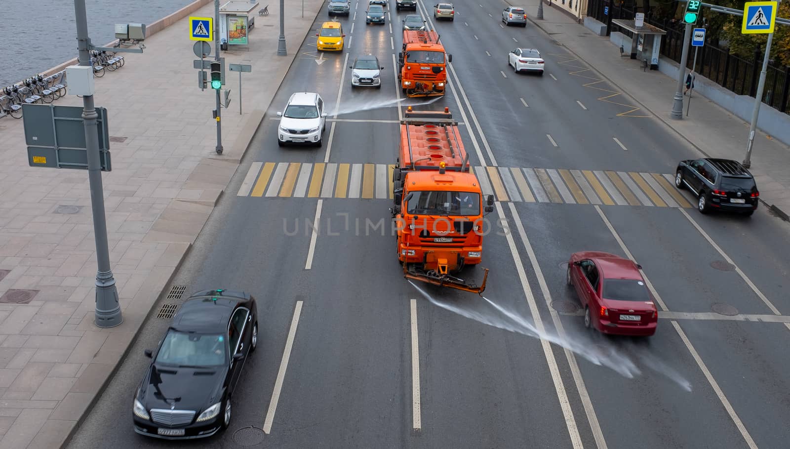 October 7, 2020, Moscow, Russia. Utility vehicles watering the street on a cloudy day.