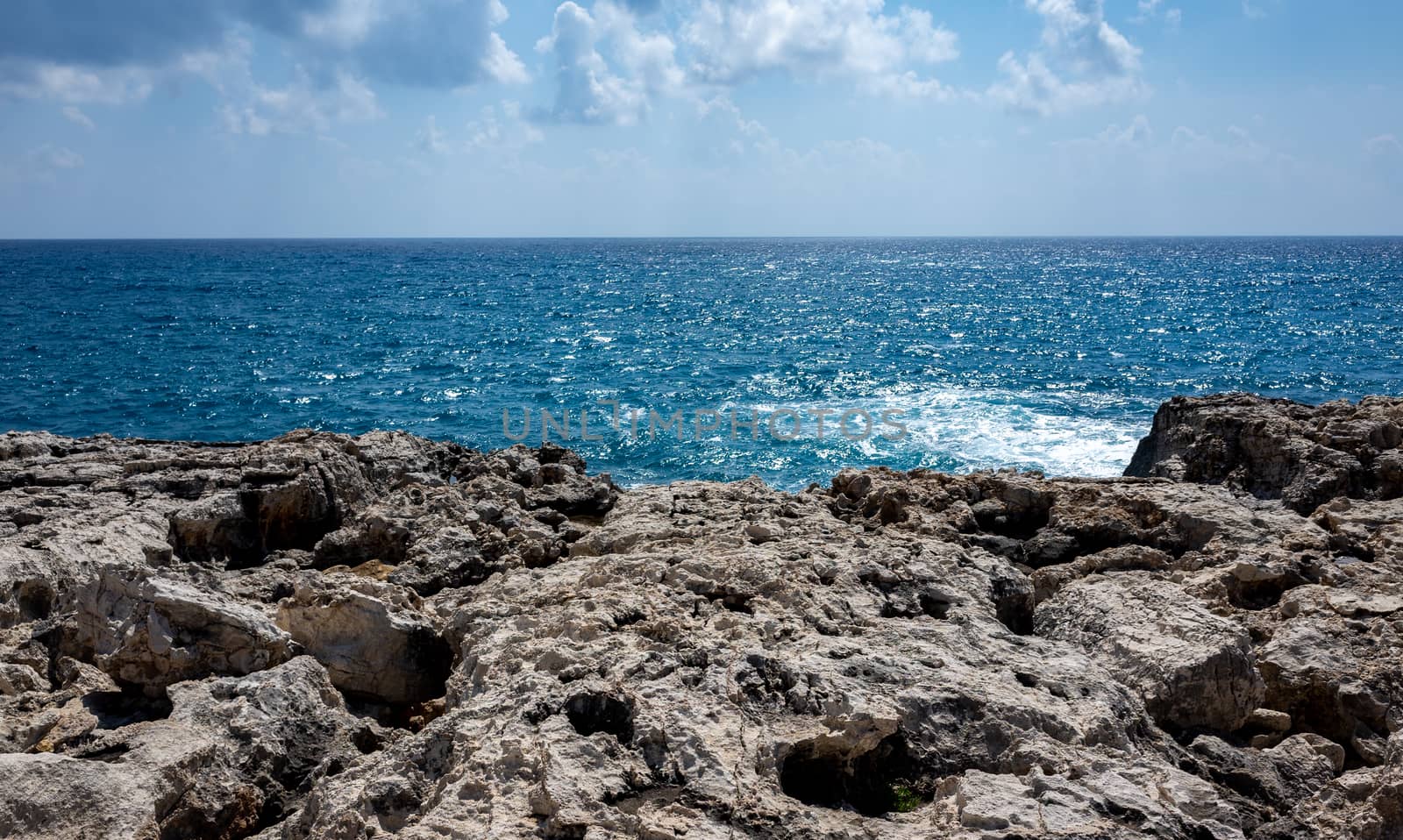 Waves crash on the rocky shore of the Mediterranean Sea on the Akamas Peninsula in the northwest of the island of Cyprus.