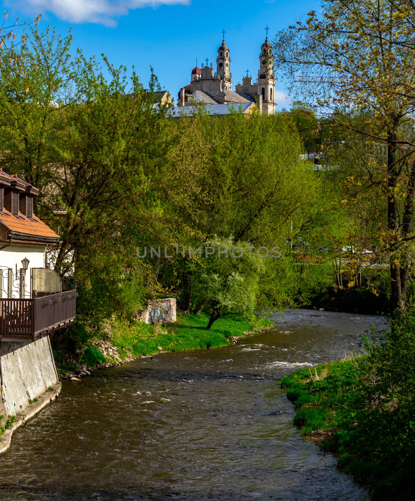 April 27, 2018 Vilnius, Lithuania, Vilnius River and Catholic church of the Ascension in Vilnius in the spring in fine weather.