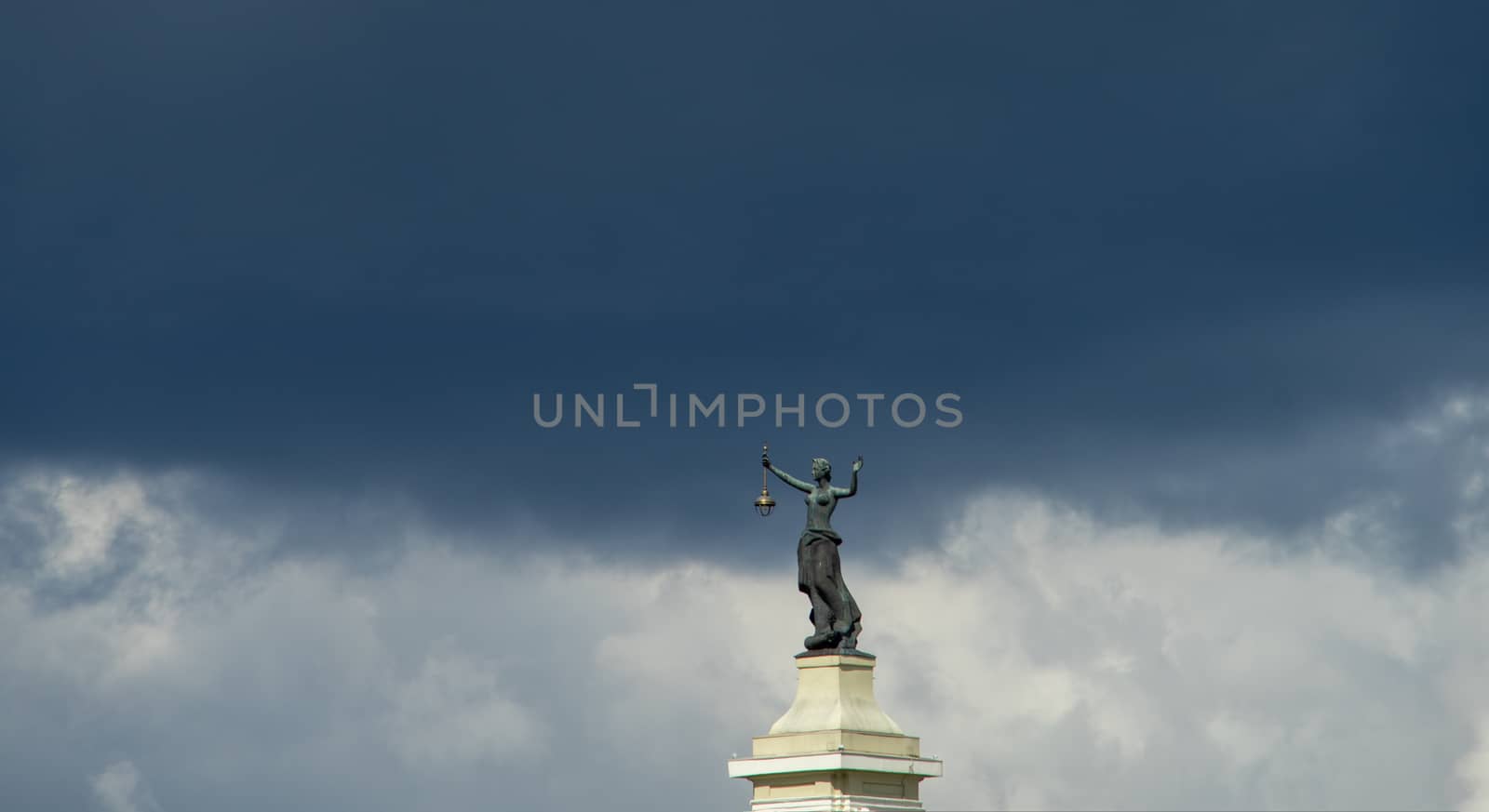 April 27, 2018 Vilnius, Lithuania. Statue of a woman with a lantern and a raised hand at the building of a former power station in Vilnius.
