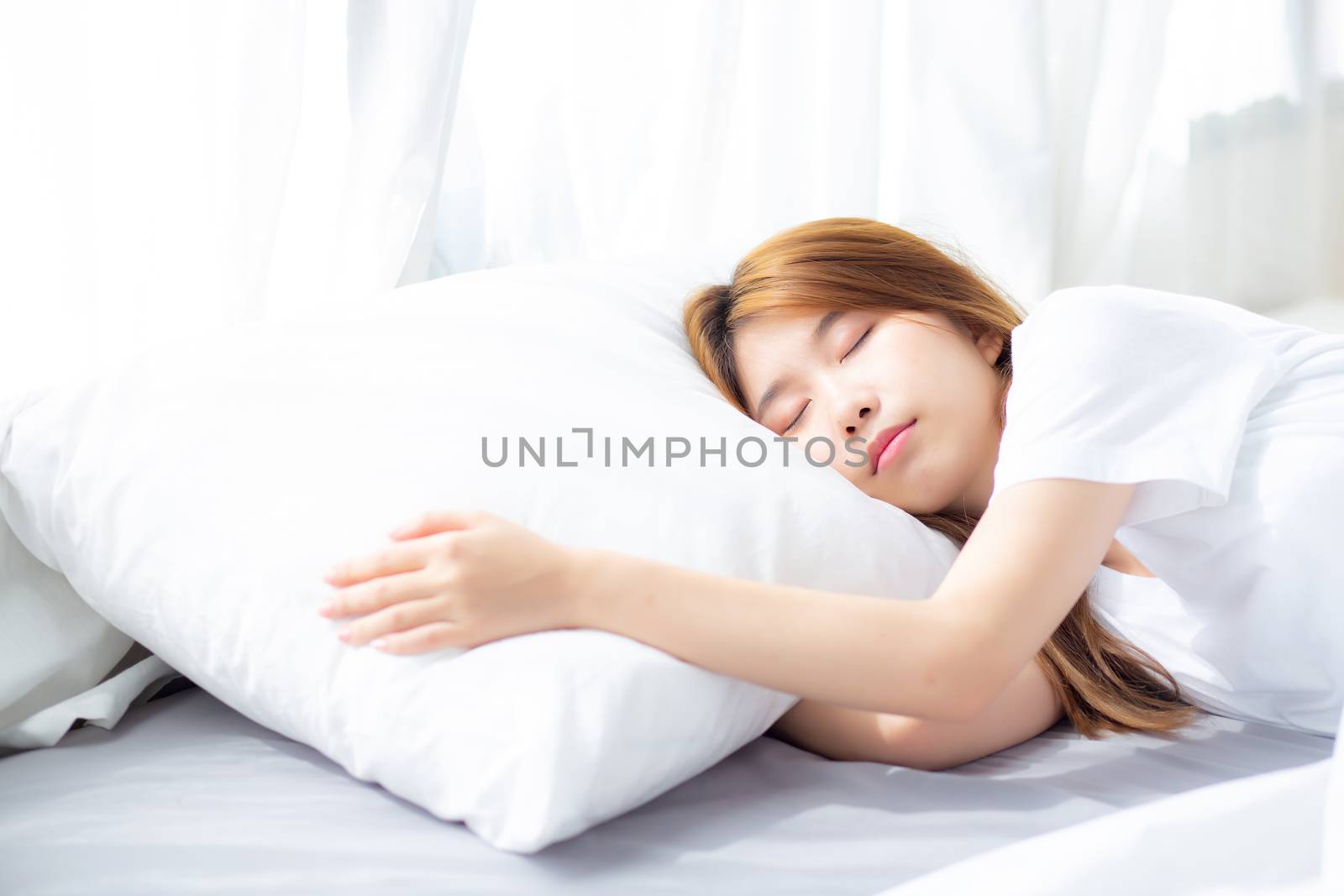 Portrait of beautiful asian young woman sleep lying in bed with head on pillow comfortable and happy with leisure, girl with relax  for health and lifestyle concept.