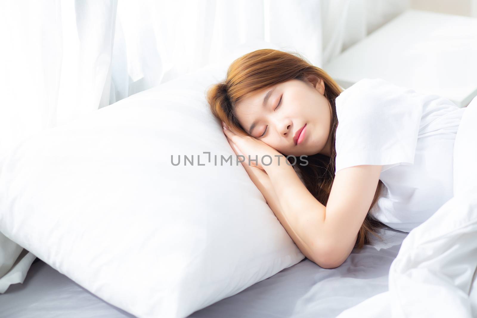 Portrait of beautiful asian young woman sleep lying in bed with head on pillow comfortable and happy with leisure, girl with relax  for health and lifestyle concept.
