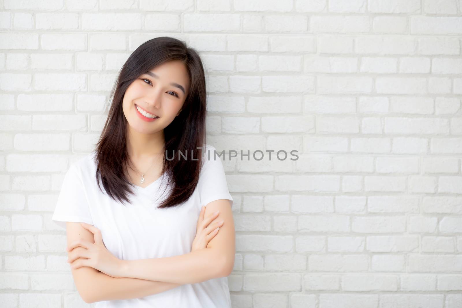 Portrait of beautiful young asian woman happiness standing on gray cement texture grunge wall brick background, businesswoman is a smiling on concrete, business people concept.