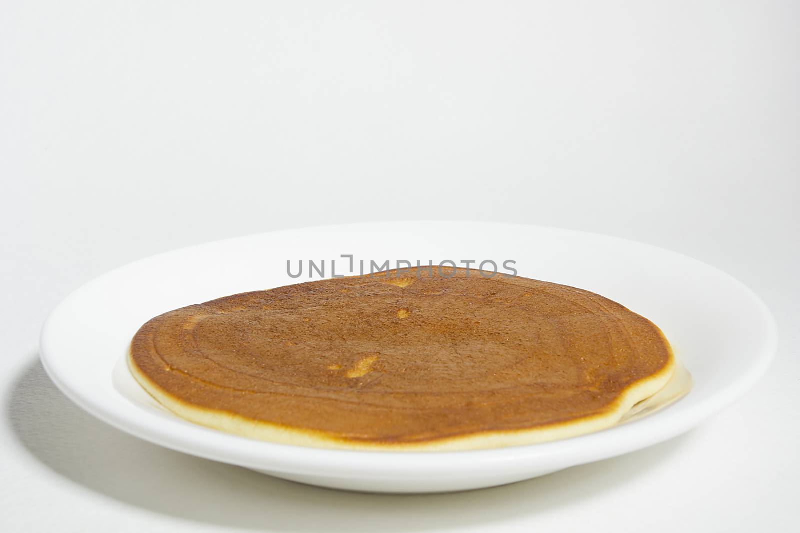 Freshly baked pancake on a plate by VIPDesignUSA