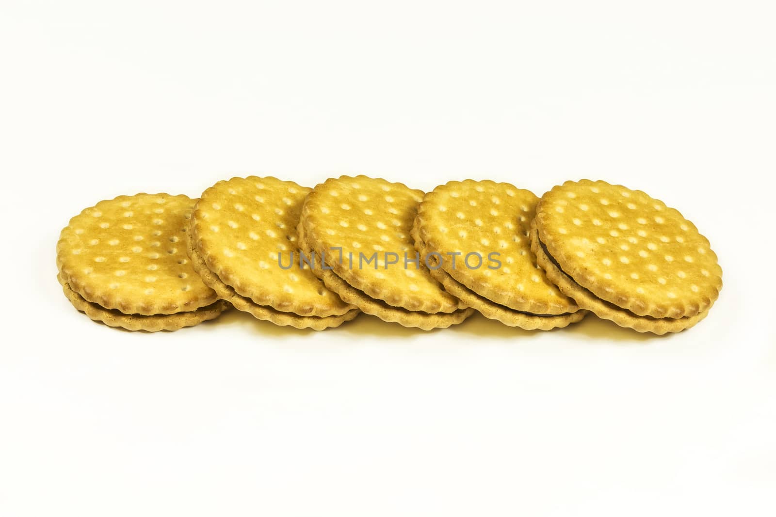 Round biscuits with chocolate filling lie on a light background by Grommik